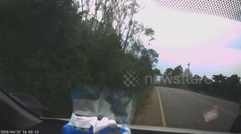 Motorcyclist wobbles and slams into the ground as car behind has to swerve to avoid him