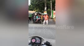 Dancing construction worker directs traffic in the Philippines