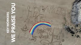 Spectacular sand tribute for key workers written into UK beach during COVID-19 pandemic