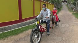 Indian father creates 'social distancing bike' so he can cycle with daughter