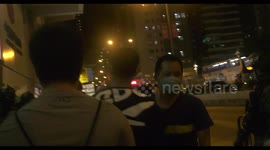 Protesters hoist a colonial flag and US flag near Prince Edward MTR station in Mongkok