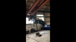 Scrap car being lifted
