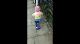 2 year old riding a scooter on a sunny day