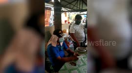 Chaotic scenes as residents cram into town hall for financial help in the Philippines