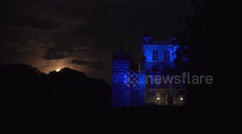 Supermoon passes behind landmark lit up in tribute to the NHS