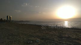 Swimmers, surfers and paddleboarders flock to the beaches of Barcelona as they reopen today