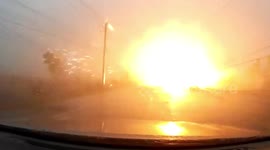 Driver narrowly avoids being electrocuted when power lines blow down in storm