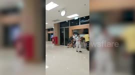 Hospital staff hold the doors shut as tropical storm batters building in Thailand