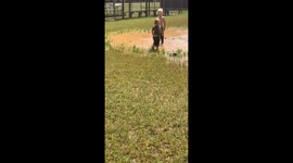 not a care in the world: 3 toddlers splashing in a mud puddle
