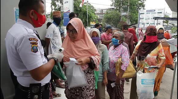 Indonesians queue for food during COVID-19 pandemic