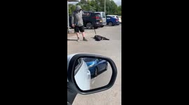 Dog plays dead in the middle of a supermarket carpark in North West England