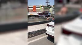 Man cools off  in fountain without his clothes as temperatures hit 38C in Vietnam