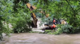 Drone used to rescue Chinese digger drivers trapped in flooded river after rainstorm