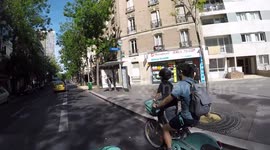Cyclist father gets his kid dangerousely on Paris public bikes Velib and doesn't stop for pedestrians.