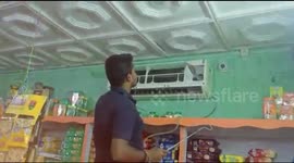 Man struggles to catch deadly cobra hiding in air conditioner of bakery in eastern India