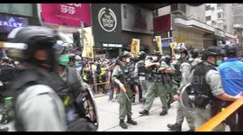 Riot police establish cordon as protesters offer sanitizer and sell figurines of 