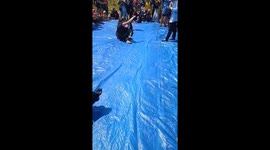 Women bend over backwards in party game to change in and out of shorts without using their hands