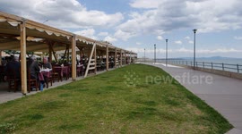 People enjoy drinks and meals in a restaurant in Alexandroupoli, Greece