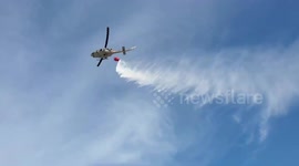 Thai army helicopters used to extinguish grass fire