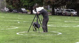 News reporters and camera operators practice physical distancing in Toronto with two meter long microphone poles and masks due to COVID 19