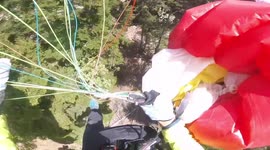 Terrifying moment two paragliders collide at nearly 5,000ft and plummet into trees