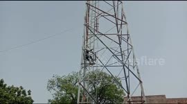 Watch - Frustated after being locked down for 2 months, drunk man clibs cell phone tower in Firozabad