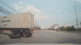 Thai motorcyclist and passenger narrowly avoid being run over by truck after bumping into it and falling down