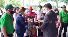 Spiderman hands out free food to locals in Thailand