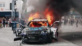 LAPD Los Angeles Police Car on fire near CBS Studios with protestors and police surrounding each other - (no copyright logo of mine on)