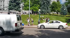 Guy carrying a cross in front of the protestors on capitol hill in Denver