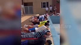 University students in China use bowls of water to learn how to swim during coronavirus pandemic