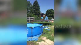 Epic fail as man attempts to jump into a pool from trampoline