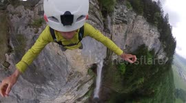 Base jumper leaps from the top of picturesque waterfall