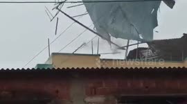 Heavy rains, strong winds lift-off asbestos roof of building in western India