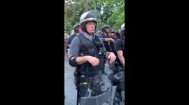 Unidentified riot police guard White House from peaceful protests