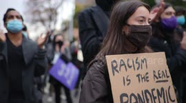 Girl holds sign saying 