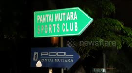 Drunk man sleeps in a pool of flood water