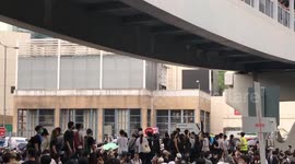 Protestors passing umbrellas to the frontline protestors at the Anti-Extradition Bill protest on 12 June 2019