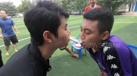Vietnamese teenagers take part in a funny game of transmitting flour by mouth