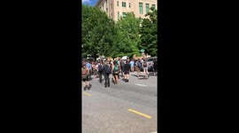 Driver dangerously drives through protest crowd
