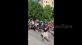 Driver dangerously drives through protest crowd in Asheville, North Carolina
