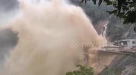 Water bursts out of penstock after it is broken by landslide at Chinese hydropower station