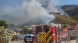 Firefighters fight to save homes from wildfire in Southern Californian neighborhood