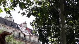 Antifa protester in Paris scales building to take down far right banner during BLM march