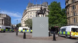 Boarded up Charles I statue surrounded by police in Trafalgar Square following a day of far-right clashes with police and BLM