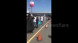 NHS workers wait in line as Sports Direct offers 50 percent off today as stores reopen