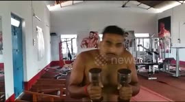 Man famous as hammer head man in india bangs dumbles on his head while practising