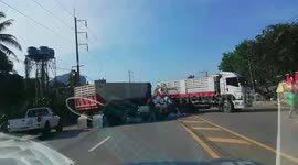 Parents and two-year-old daughter emerge unhurt after car is crushed by truck