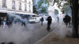 Masked and hooded individuals throw projectiles at police in Paris
