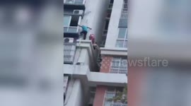 Chinese men risk their lives to rescue four-year-old trapped on 14th-floor building ledge